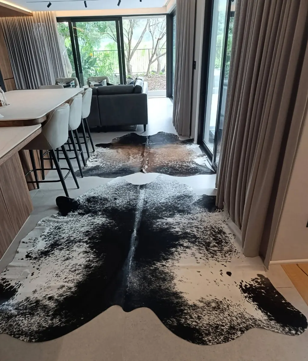 Two speckled Nguni hides in an open-plan kitchen and lounge